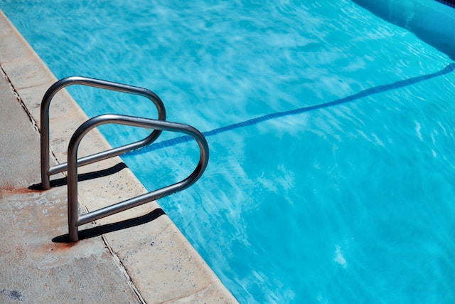 Pool Cleaning Tips - Picture of handrails next to the deep end of a swimming pool
