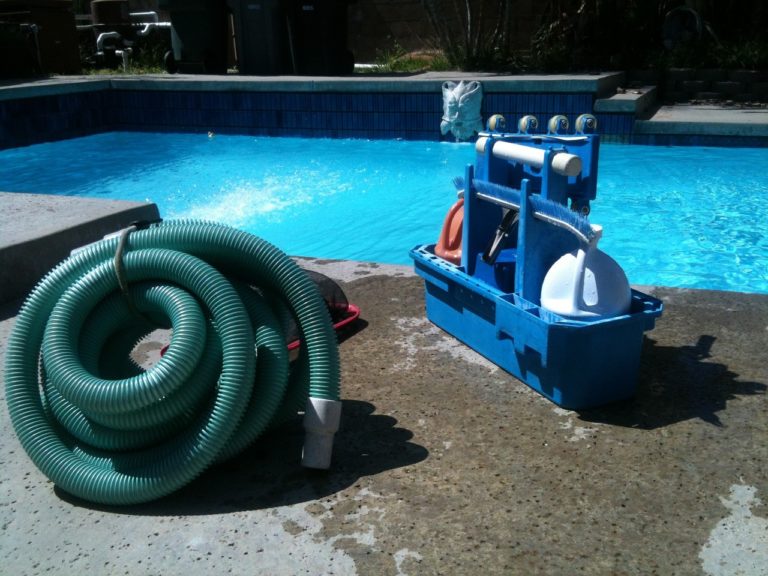 Las Vegas pool cleaning - pool cleaning equipment sitting next to a pool
