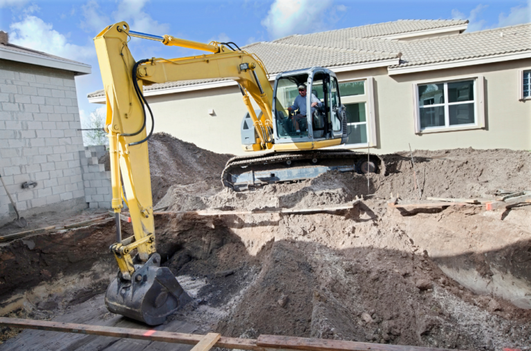 Contractor using an extractor for pool construction